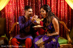 Indian groom giving bride something to eat Indian groom giving bride something to eat