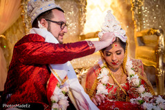 Indian groom performing the sindhoor ritual. Indian groom performing the sindhoor ritual.
