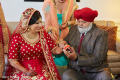 Indian bride being helped with jewelry Indian bride being helped with jewelry