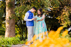 Charming indian groom looking at bride's mehndi Charming indian groom looking at bride's mehndi