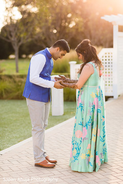 Indian bride showing mehndi art to groom Indian bride showing mehndi art to groom