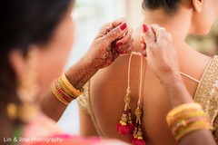 Indian bride being helped to get ready Indian bride being helped to get ready