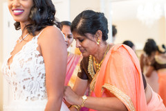 Indian bride being helped to get ready Indian bride being helped to get ready