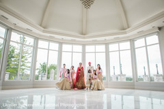 Glamorous indian bride and groom posing with bridesmaids Glamorous indian bride and groom posing with bridesmaids