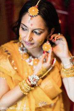 Indian wedding ritual of painting the bride with yellow turmeric paste Indian wedding ritual of painting the bride with yellow turmeric paste