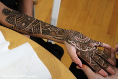 Indian bride getting mehndi art done Indian bride getting mehndi art done