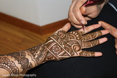 Indian bride getting mehndi art done scene Indian bride getting mehndi art done scene