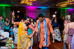 Indian couple dancing during sangeet Indian couple dancing during sangeet