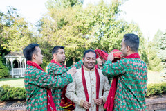 Indian groomsmen helping groom to get ready Indian groomsmen helping groom to get ready