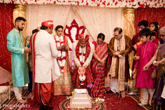 Indian groom making offerings to sacred fire Indian groom making offerings to sacred fire