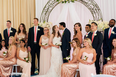 Lovely indian couple posing with bridesmaids and groomsmen Lovely indian couple posing with bridesmaids and groomsmen