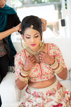 Indian bride getting help with jewelry Indian bride getting help with jewelry
