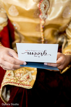 Indian groom reading card from bride Indian groom reading card from bride