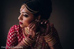 Sweet indian bride putting earrings on Sweet indian bride putting earrings on