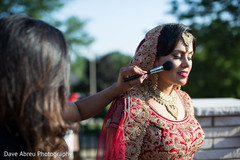 Beautiful indian bride being dolled up for her ceremony indian wedding gallery,outdoor photography,indian bride jewelry,indian bride getting ready