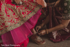 Indian bride being helped to get ready Indian bride being helped to get ready