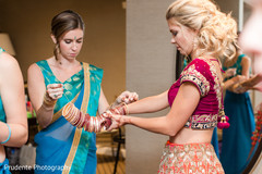 Sweet indian bride putting bangles on indian wedding gallery,indian bride getting ready,indian bride fashion,bridal jewelry