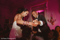 Indian bride and groom being lifted up during wedding reception indian wedding reception,indian wedding reception photography,indian bride and groom