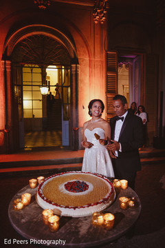 Indian newlyweds cutting the cake capture indian wedding reception,indian wedding reception photography,indian bride and groom