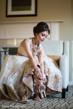 Lovely indian bride putting shoes on Lovely indian bride putting shoes on