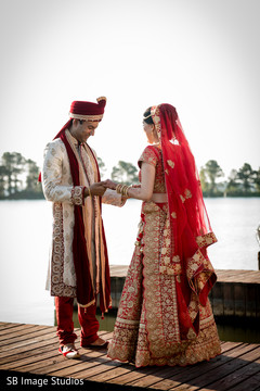 Indian groom admiring bridal mehndi art Indian groom admiring bridal mehndi art