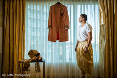 Indian groom checking his sherwani Indian groom checking his sherwani
