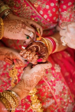 Indian bride being helped with jewelry Indian bride being helped with jewelry