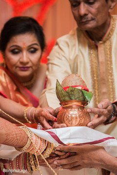 Family, bride and groom holding the coconut for the wedding Jai Mala Ceremony. Family, bride and groom holding the coconut for the wedding Jai Mala Ceremony.