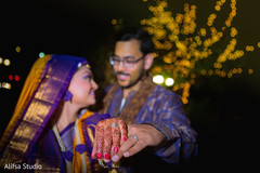 Indian lovebirds showing wedding rings Indian lovebirds showing wedding rings