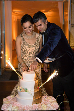 Indian newlyweds cutting their wedding cake Indian newlyweds cutting their wedding cake