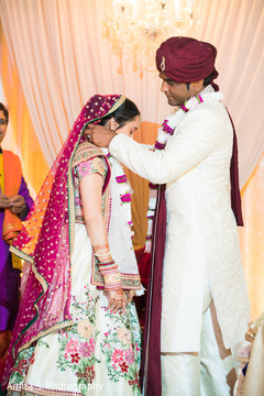Indian groom putting flower garland to bride. Indian groom putting flower garland to bride.