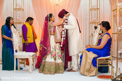Indian bride putting flower garland to groom. Indian bride putting flower garland to groom.