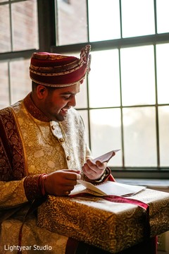 Sweet indian groom reading card from bride Sweet indian groom reading card from bride