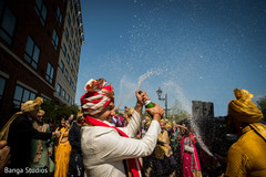 Indian groom opening up a champagne bottle Indian groom opening up a champagne bottle
