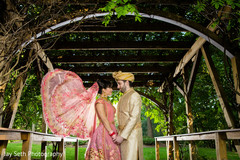 Indian bride and groom looking at each other on their wedding traditional outfits. Indian bride and groom looking at each other on their wedding traditional outfits.
