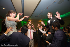 Indian bride and groom being lifter on their wedding reception dance. Indian bride and groom being lifter on their wedding reception dance.