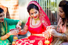 Indian bride being helped by bridesmaids to get ready for wedding ceremony. Indian bride being helped by bridesmaids to get ready for wedding ceremony.