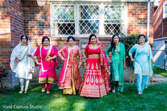 Indian bride and bridesmaids posing for an out door photo. Indian bride and bridesmaids posing for an out door photo.