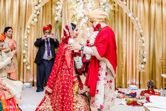 Indian groom putting flower garland to bride. Indian groom putting flower garland to bride.