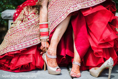 Indian bride putting her ceremony golden shoes. bridal shoes,indian bride shoes,indian bride jewelry,indian bride golden shoes