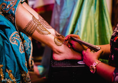 Henna artist making mehndi art Henna artist making mehndi art