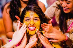 Indian bride is smeared in yellow turmeric paste at her first wedding ceremony ritual Indian bride is smeared in yellow turmeric paste at her first wedding ceremony ritual