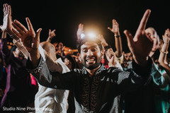 Indian groom posing for camera during sangeet dance. Indian groom posing for camera during sangeet dance.