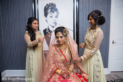 Indian bride being helped to put her Ghoonghat. Indian bride being helped to put her Ghoonghat.