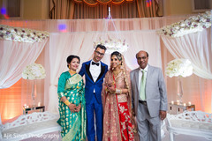 Indian bride and groom posing with parents. Indian bride and groom posing with parents.