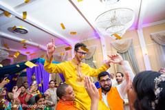 Indian groom being carried by guests on his pre wedding celebration. Indian groom being carried by guests on his pre wedding celebration.