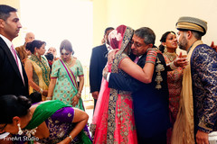 Indian wedding family hugging the couple bridal lengha,post ceremony moments,indian wedding