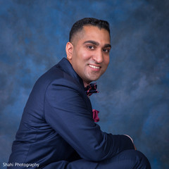 Elegant Indian groom posing for photo on his wedding reception outfit. indian groom,indian wedding fashion