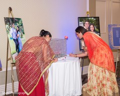 Indian wedding guests signing memory book for bride and gr Indian wedding guests signing memory book for bride and gr