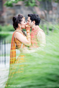 Lovely Indian couple kissing outdoors of mehndi venue. Lovely Indian couple kissing outdoors of mehndi venue.